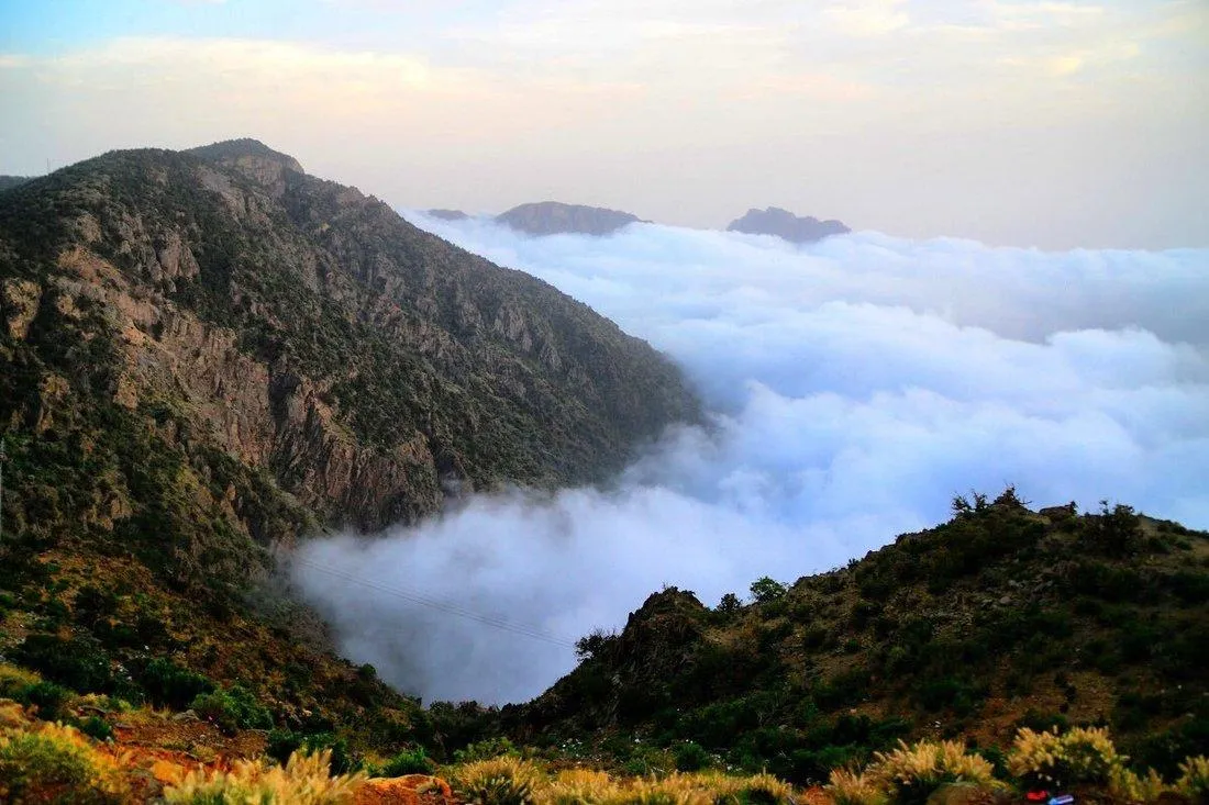 Scenic view of Al Soudah peaks above clouds