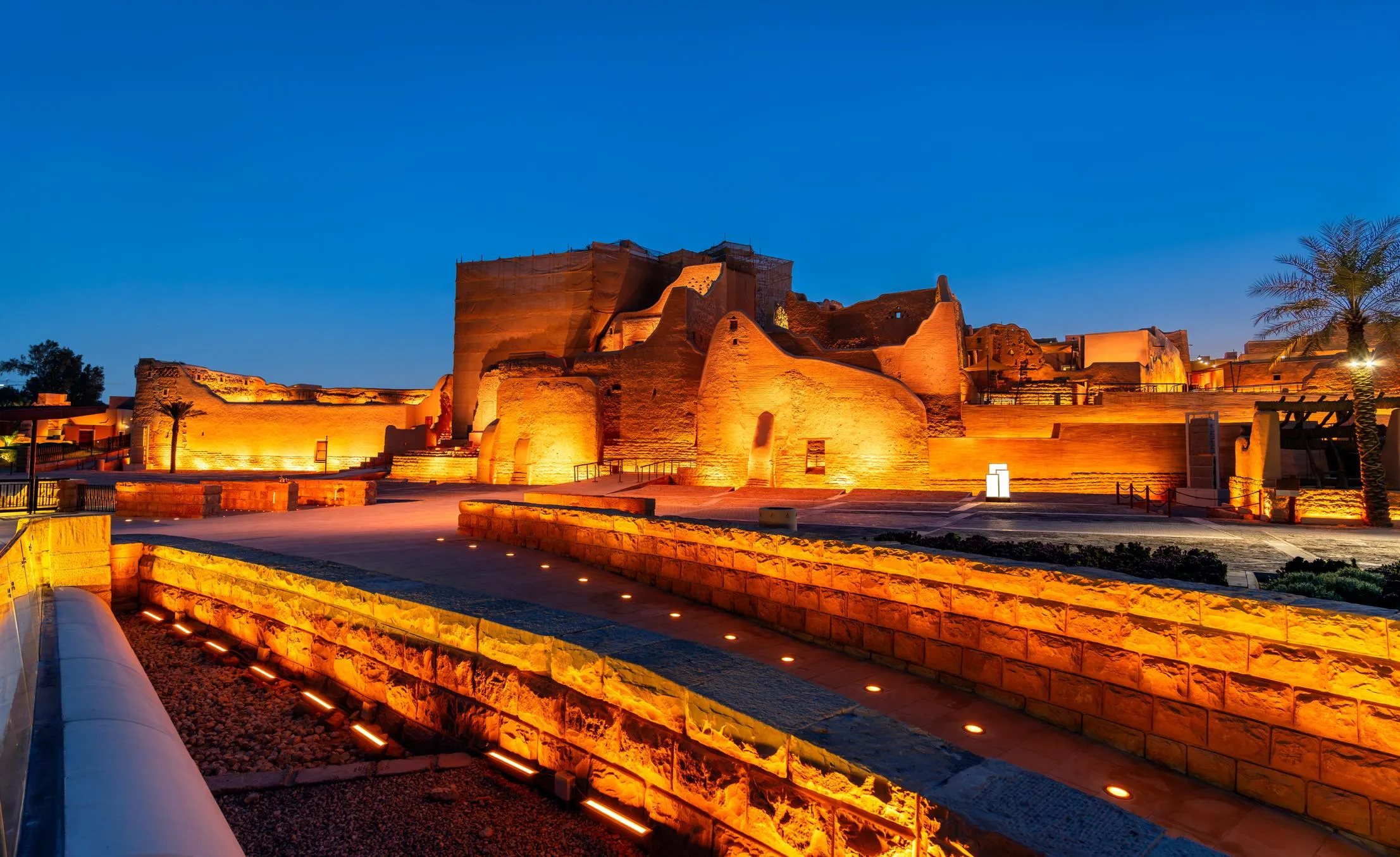 Night pathway along At-Turaif illuminated ruins Diriyah
