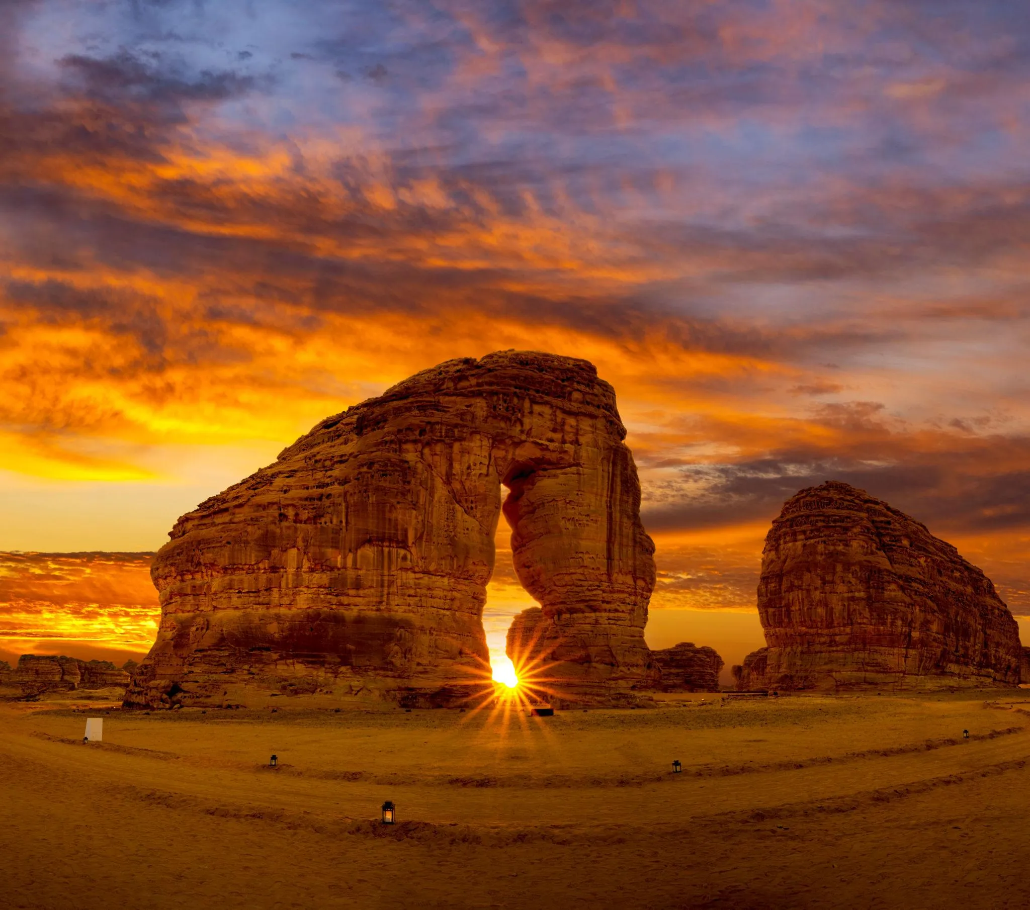Sun flare behind Elephant Rock AlUla at sunset