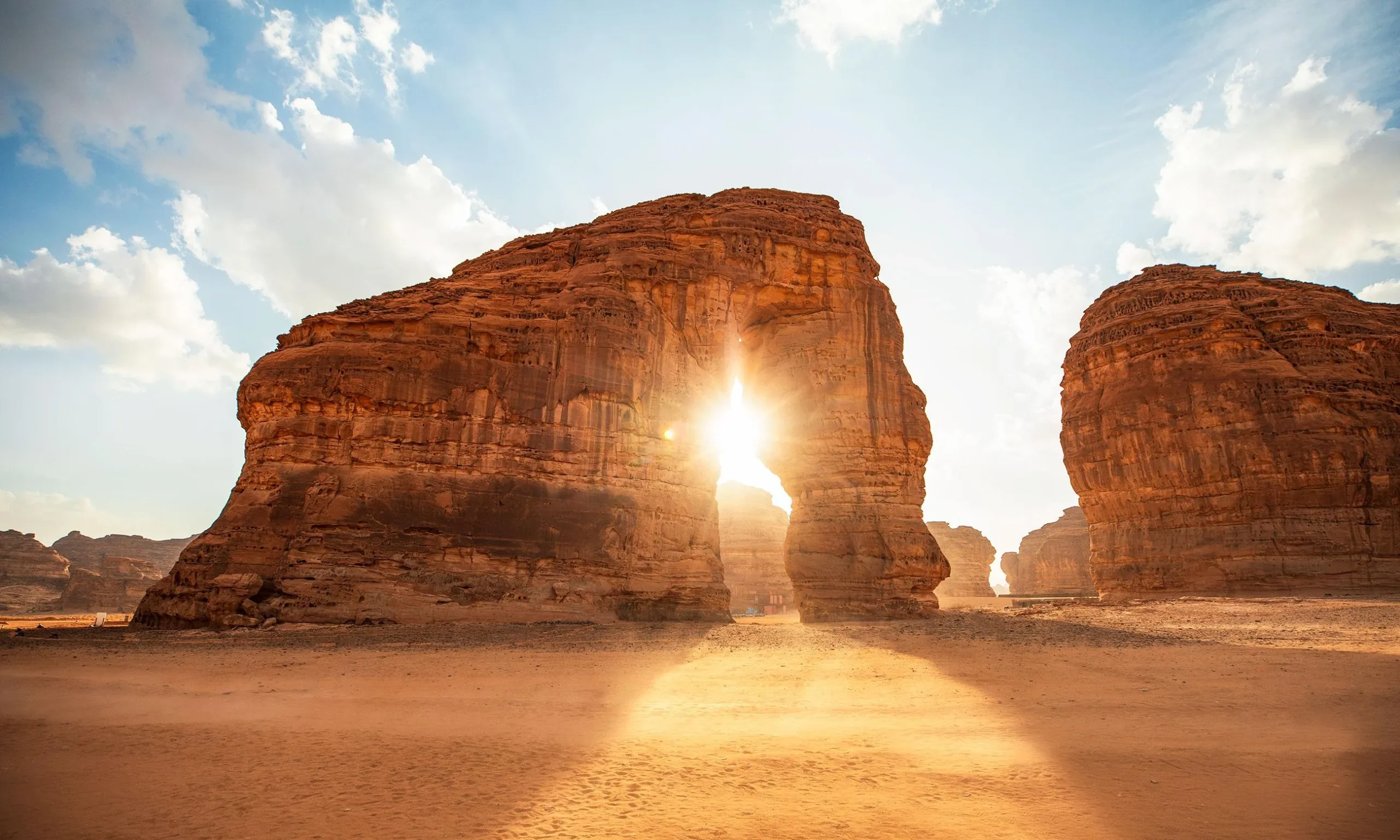 Elephant Rock AlUla sunlight arch in daytime desert