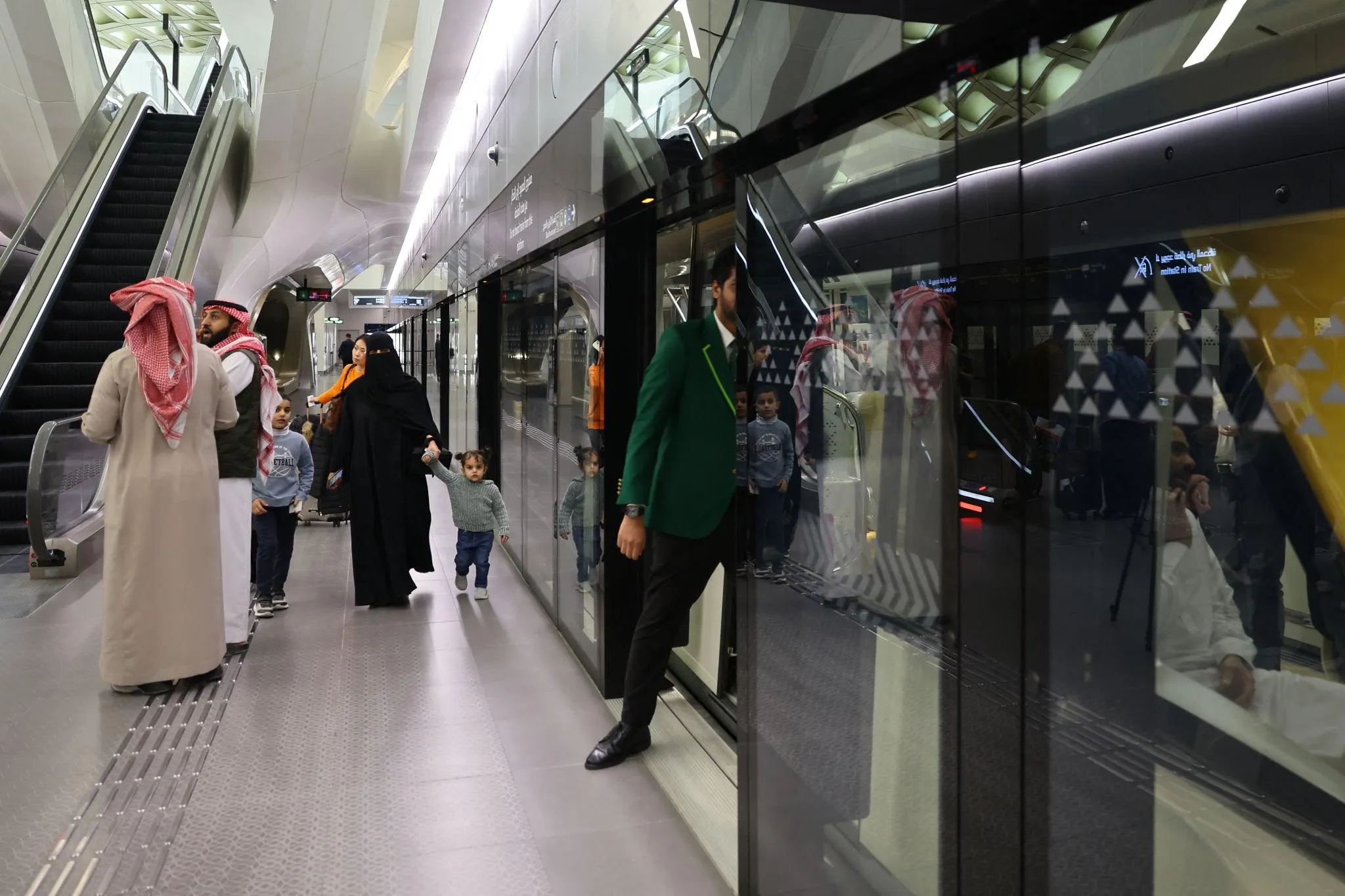 Passengers boarding train at Riyadh Metro passenger station