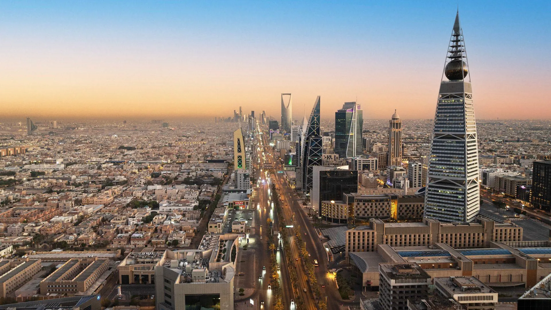 Riyadh city skyline at sunset with illuminated Al Faisaliah Tower